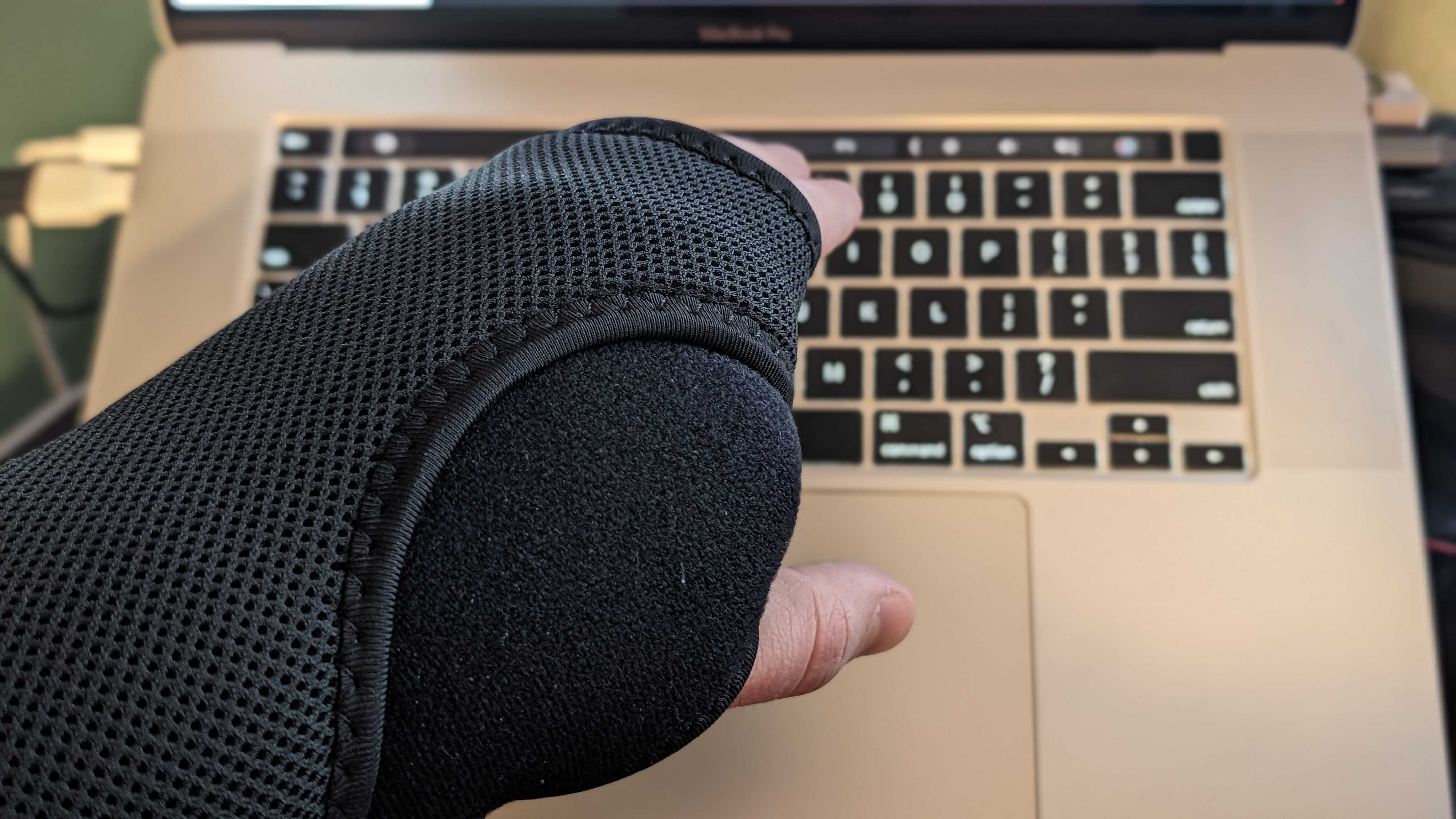 hand in brace hovering over a keyboard
